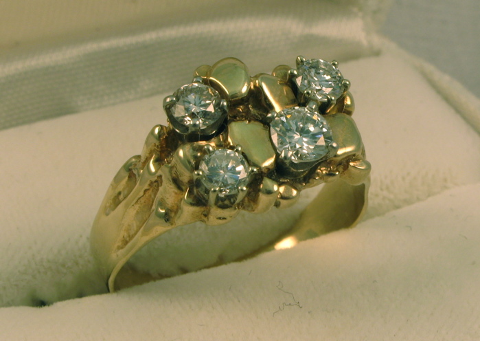 Appraisal: MAN'S DIAMOND AND FOURTEEN KARAT GOLD RING set with four