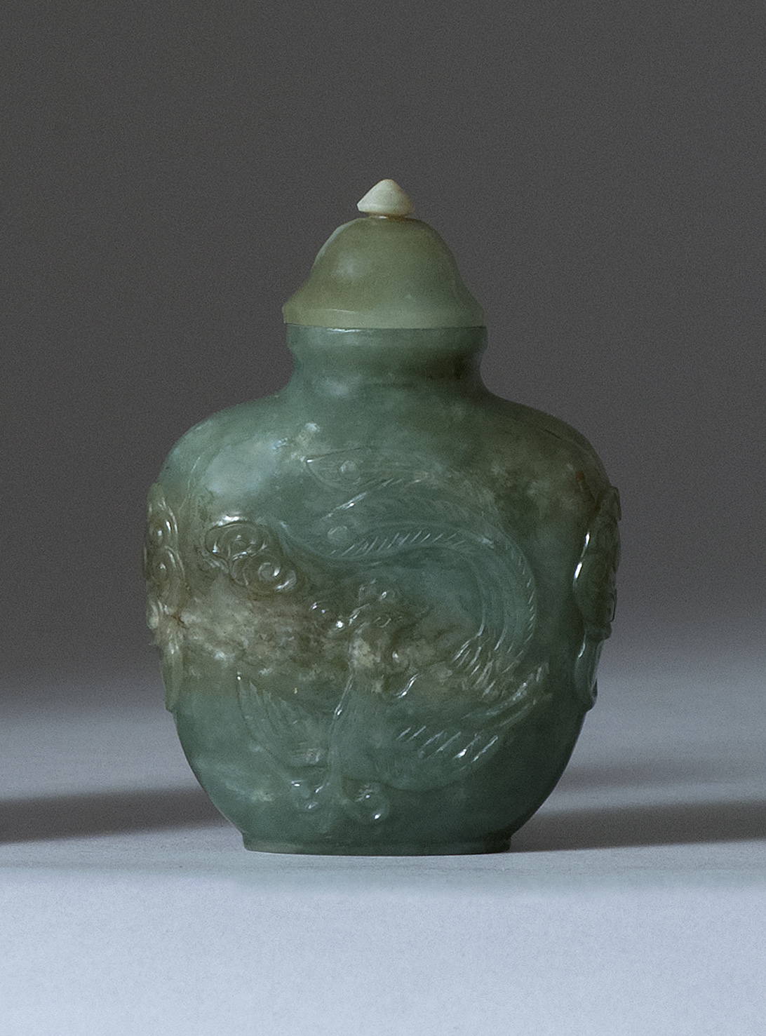 Appraisal: GREEN JADEITE SNUFF BOTTLE Early th CenturyIn temple jar form