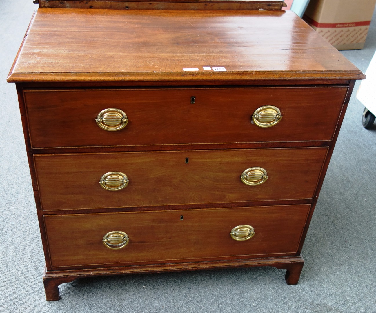 Appraisal: A George III mahogany chest with three long graduated drawers