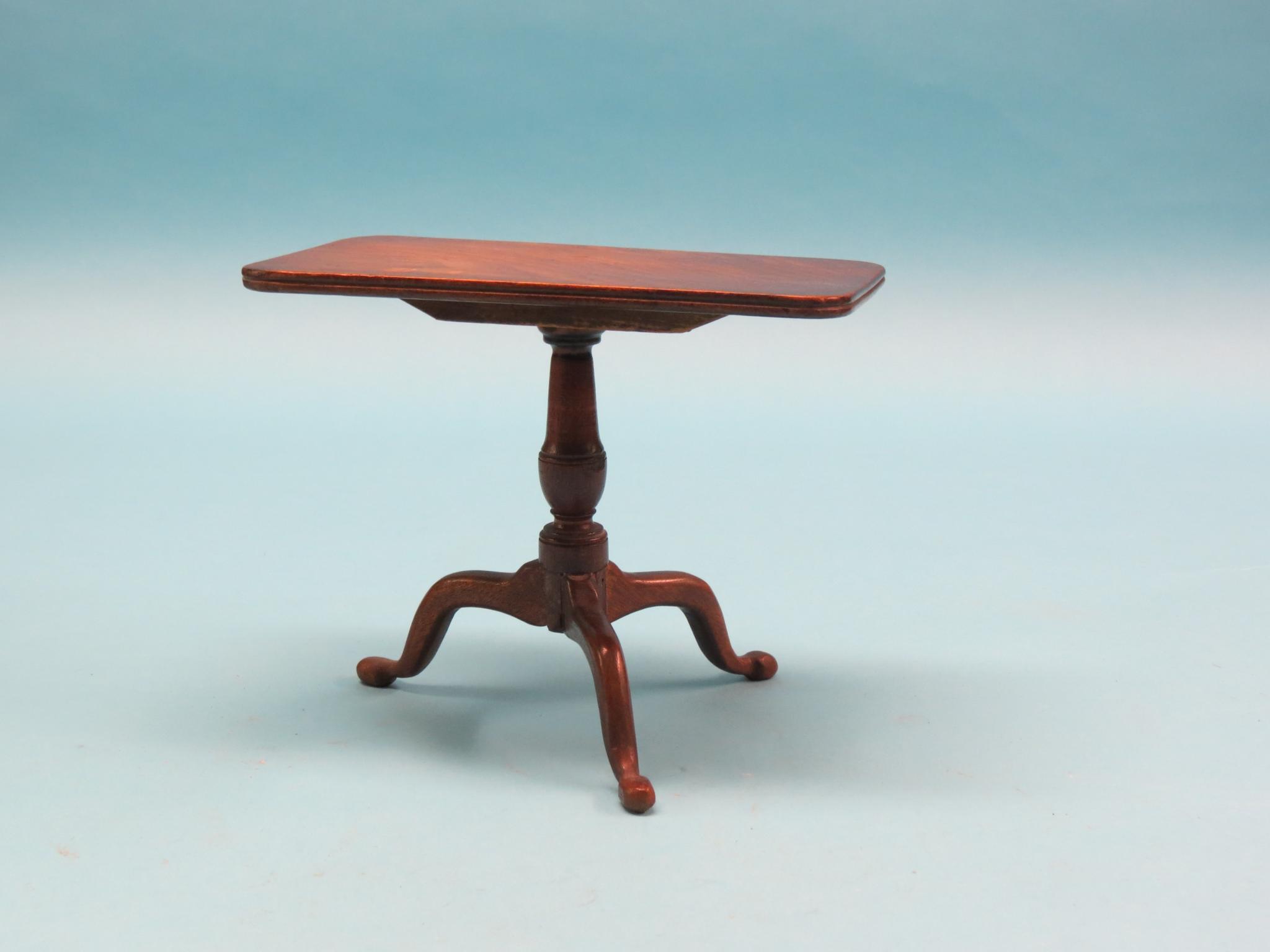 Appraisal: A Georgian-style miniature mahogany tripod table rectangular top tilting on