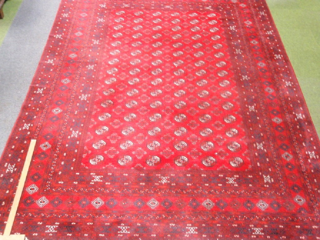 Appraisal: A red ground multi-gul Bokhara type carpet cm x cm