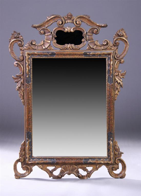 Appraisal: CONTINENTAL ROCOCO-STYLE EBONIZED GILTWOOD LOOKING GLASS th century With openwork