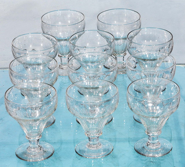 Appraisal: A SET OF ELEVEN GEORGIAN STYLE GLASS GOBLETS with fluted