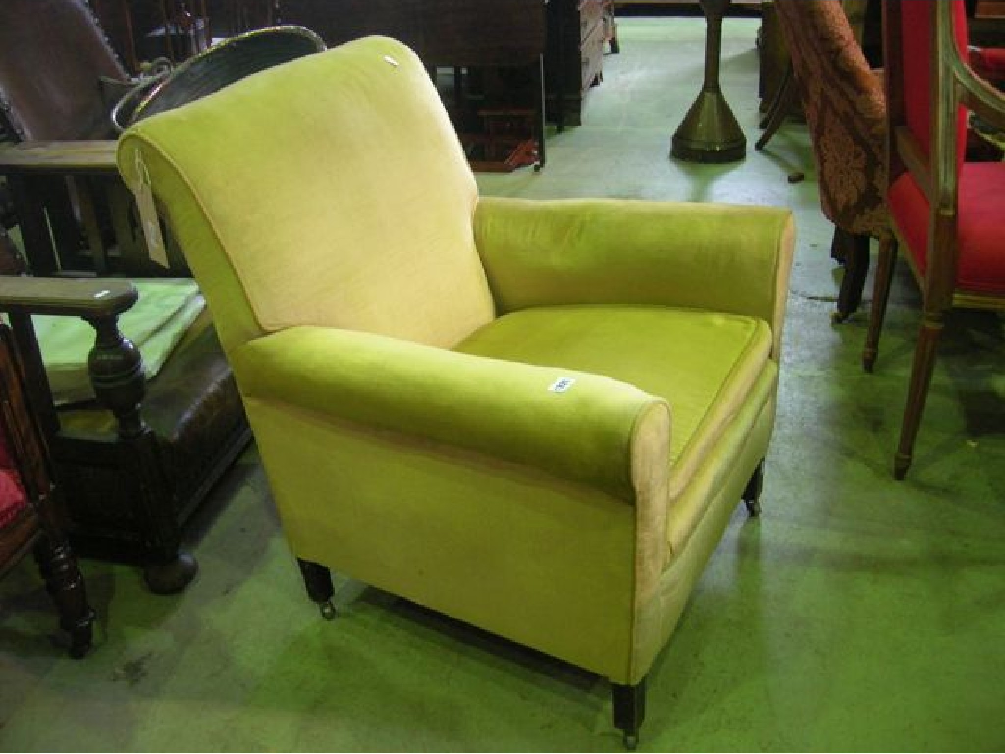 Appraisal: An Edwardian armchair with rolled arms and scrolled back upholstered