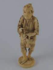 Appraisal: A Japanese sectional bone carving of a peasant with pipe