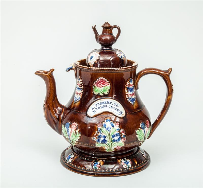 Appraisal: English Relief-Decorated Brown-Glazed Bargeware Teapot and Cover With separate stand