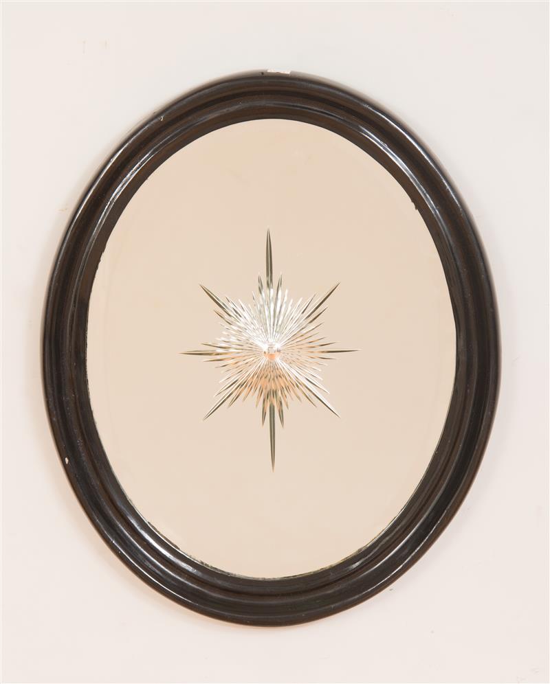 Appraisal: Black Painted Cast-Metal Oval Frame With engraved starburst mirror plate