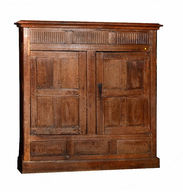 Appraisal: A Georgian oak storage cupboardenclosed by two panel doors with