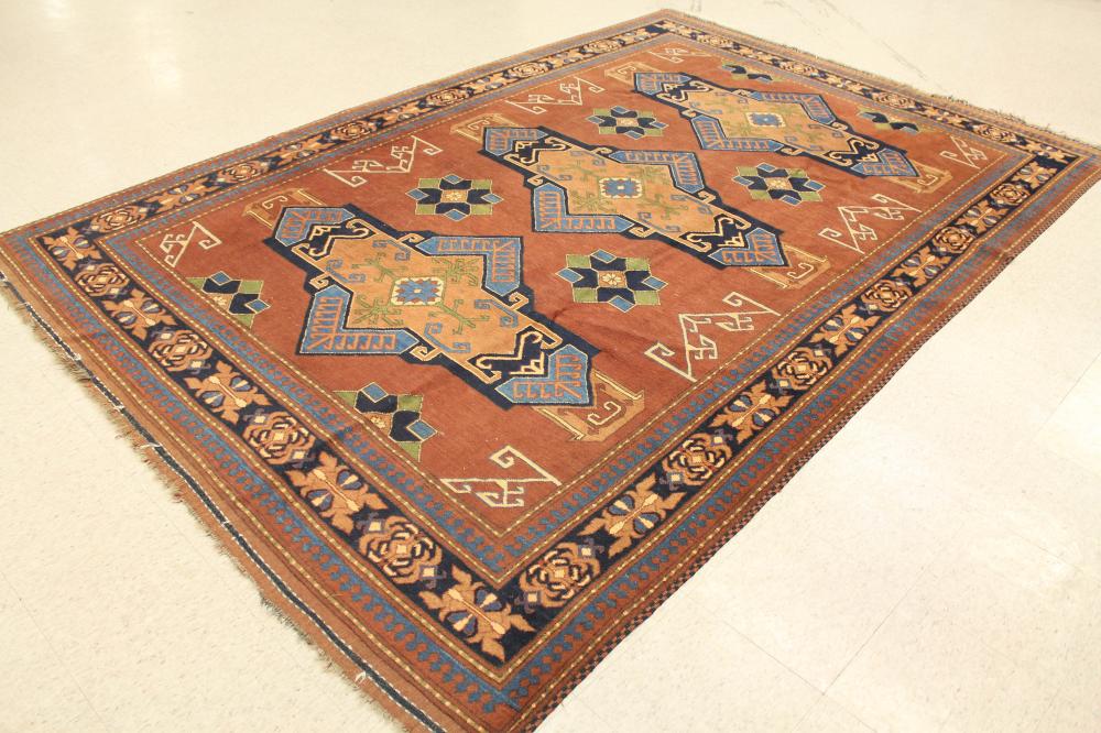 Appraisal: HAND KNOTTED ORIENTAL CARPET Pakistani Caucasian three geometric medallions design