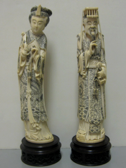 Appraisal: PAIR OF CHINESE IVORY ANCESTRAL FIGURES Depicting Emperor with sword