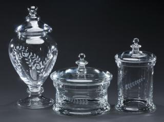 Appraisal: Etched glass lidded containers Group of three etched glass storage