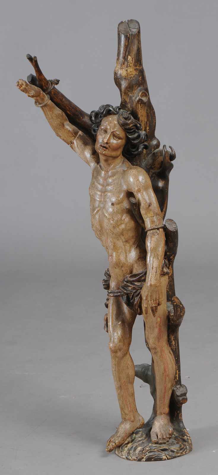 Appraisal: CONTINENTAL CARVED POLYCHROME FIGURE OF ST SEBASTIAN The nude saint