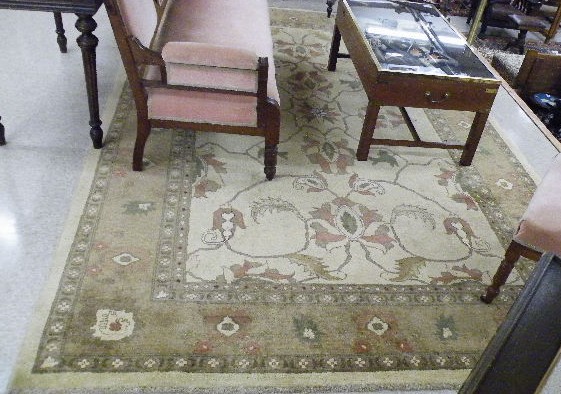 Appraisal: HAND KNOTTED ORIENTAL CARPET Pakistani-Persian the plain khaki ground lightly