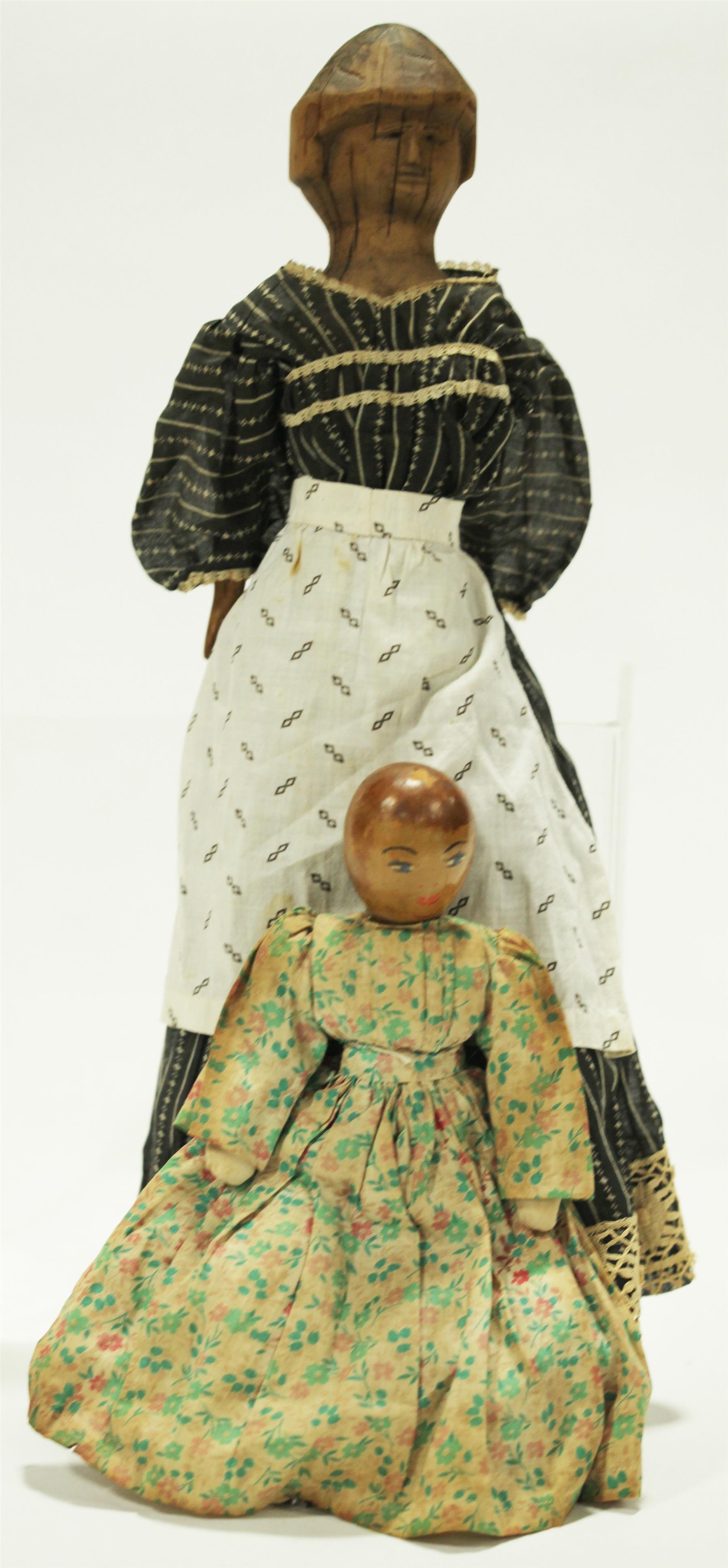 Appraisal: TWO WOODEN DOLLS Nineteenth- th century A large inch carved