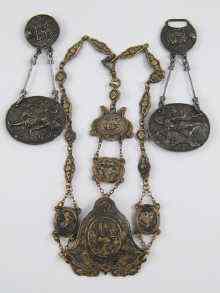 Appraisal: A gilt metal chatelaine with embossed decoration circa together with