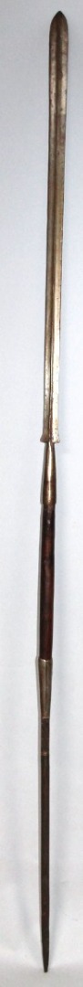 Appraisal: An African tribal spear the centre with cylindrical wooden handle