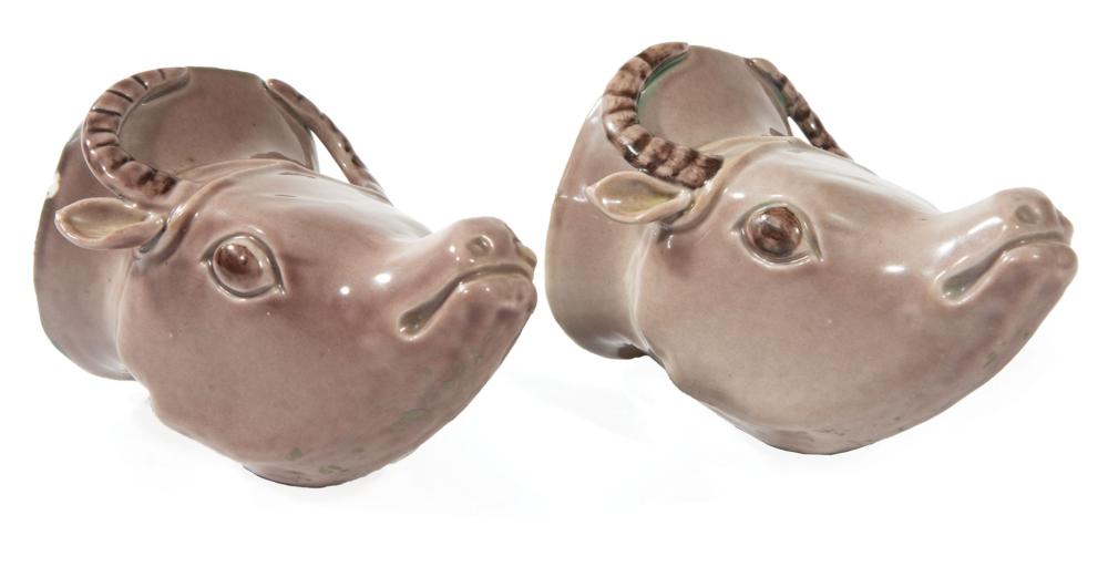 Appraisal: Pair of Chinese Aubergine Glazed Porcelain Bull's Head Rhytons Qing