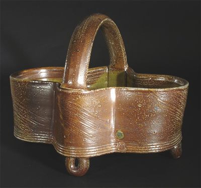 Appraisal: A Michael Casson stoneware basket covered in a mottled green