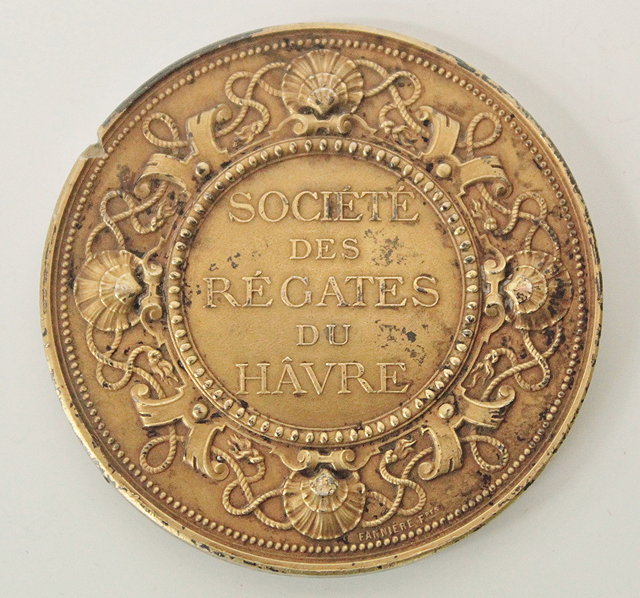 Appraisal: A GILT METAL SAILING MEDALLION the obverse with Coat of