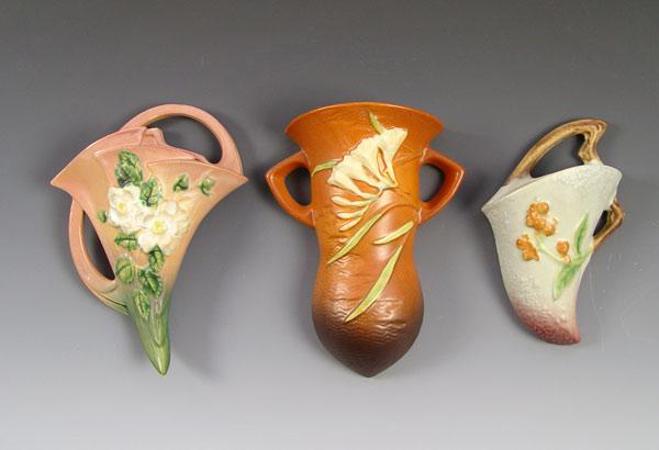 Appraisal: THREE ROSEVILLE POTTERY WALL POCKETS White Rose Freesia and Bittersewwt