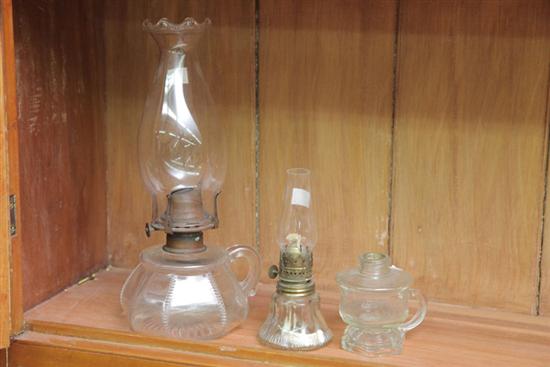 Appraisal: THREE GLASS FINGER LAMPS Including one pressed glass finger lamp