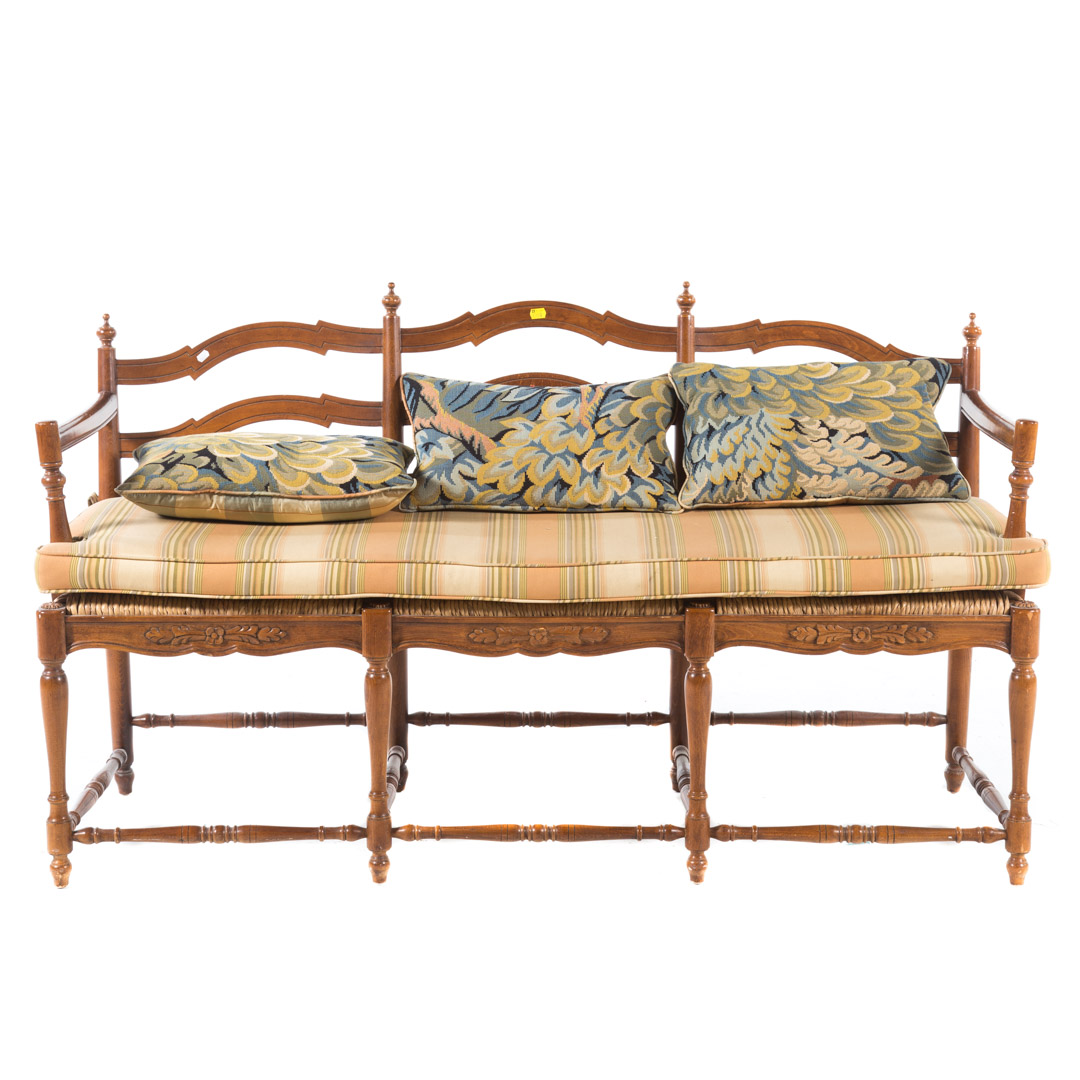 Appraisal: French Country style fruitwood rush-seat settee triple chair back with