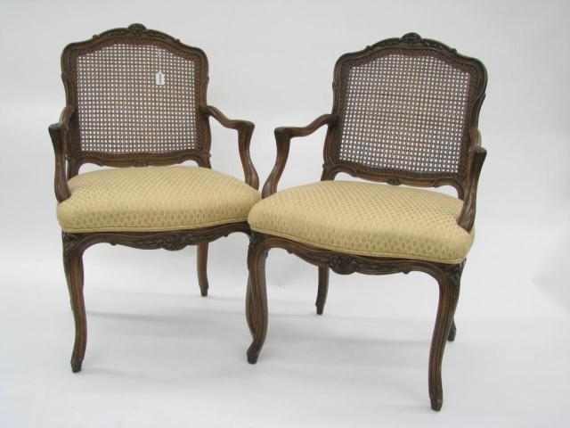 Appraisal: A pair of French period-style open arm chairs with cane