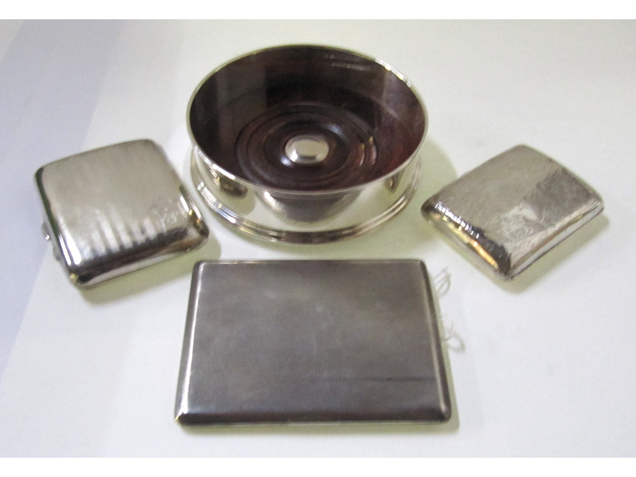 Appraisal: A lot comprising three silver cigarette cases and a silver