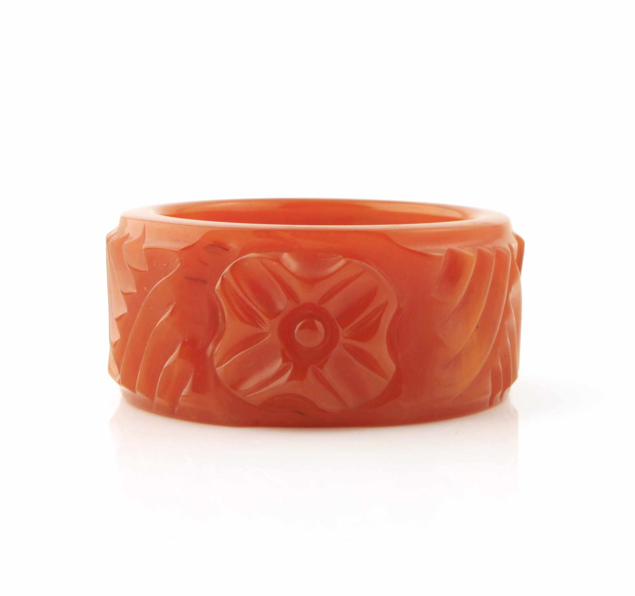 Appraisal: A deeply carved honey Bakelite bangle bracelet each diameter in