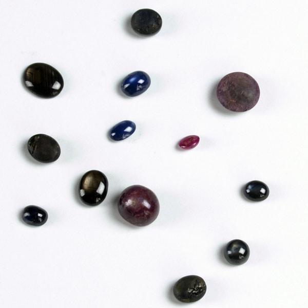 Appraisal: TWELVE UNMOUNTED GEMTONES Star rubies or sapphires cts TW