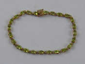 Appraisal: A yellow metal tests carat gold peridot bracelet approx cm