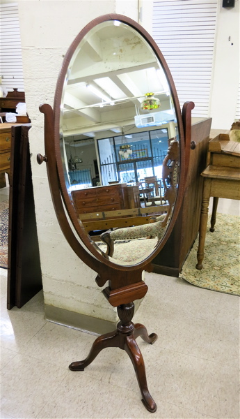 Appraisal: FREESTANDING MAHOGANY CHEVAL MIRROR an oval beveled and mahogany framed