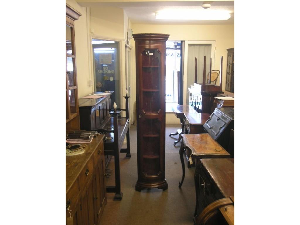 Appraisal: A narrow mahogany corner cabinet five lined shelves enclosed by