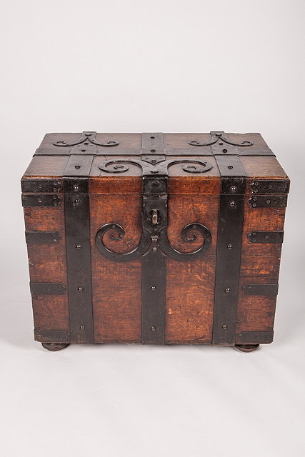 Appraisal: A TH CENTURY OAK TRUNK with iron banding and handles