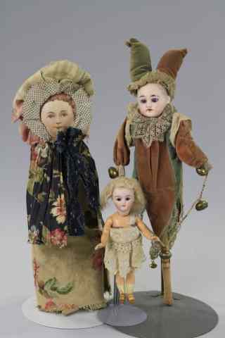 Appraisal: LOT OF THREE DOLLS Consists of a bisque head jester