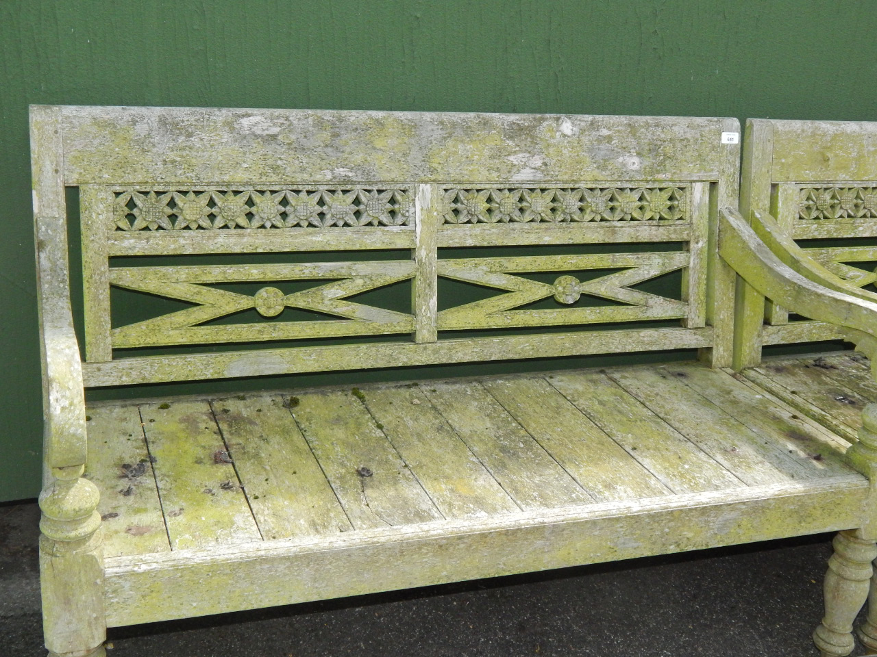 Appraisal: A two seater garden bench with a pierced and carved