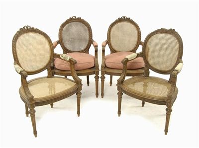 Appraisal: A set of four French carved walnut fauteuil with oval