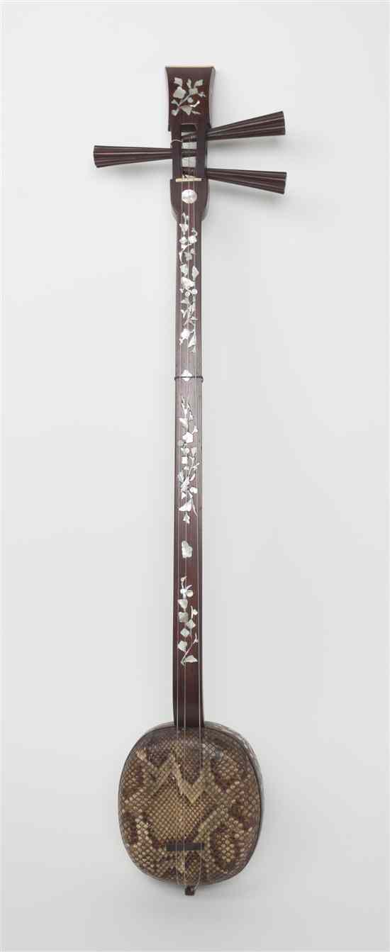 Appraisal: A Japanese Mother-of-Pearl and Snakeskin Shamisen having a mother-of-pearl inlaid