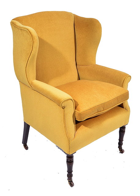 Appraisal: A GEORGE IV UPHOLSTERED MAHOGANY WING ARMCHAIR on ring turned