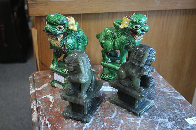 Appraisal: A PAIR OF ORIENTAL JADEITE DOGS OF FO cm high