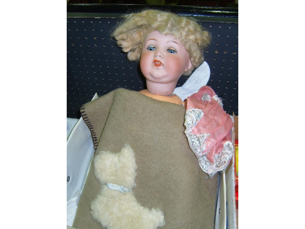 Appraisal: A bisque headed doll with closing blue eyes and open