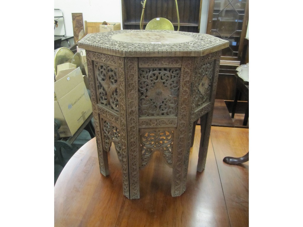 Appraisal: Burmese carved octagonal table on folding stand