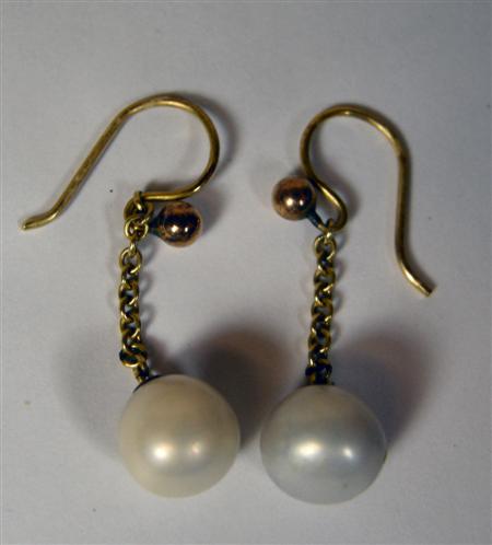 Appraisal: A pair of pearl earrings the pearl in rubover mount