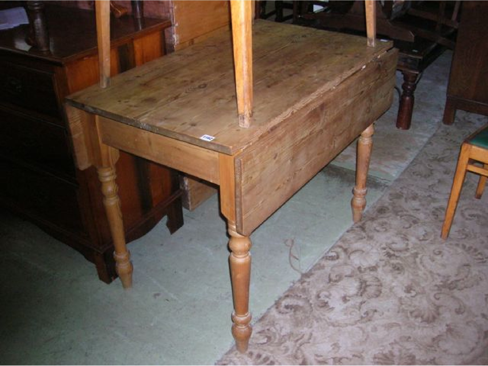 Appraisal: A stripped pine Pembroke type table raised on four turned