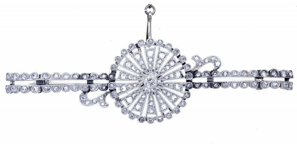 Appraisal: A PLATINUM AND DIAMOND BROOCH with a rosette of millegrain