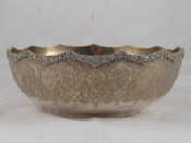 Appraisal: A Persian silver standard bowl with applied floral stiffening rim