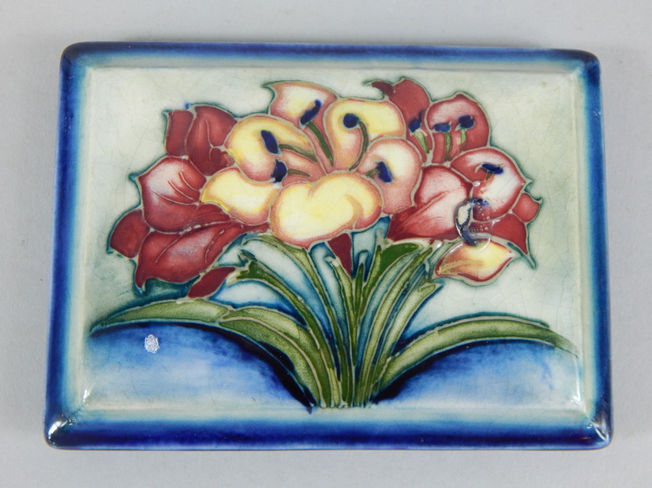 Appraisal: A Moorcroft rectangular pot lid decorated with a group of