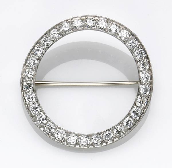 Appraisal: A diamond and platinum circle brooch estimated total diamond weight