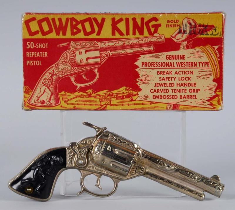 Appraisal: Cast Iron Cowboy King Gold Cap Gun Description Includes box