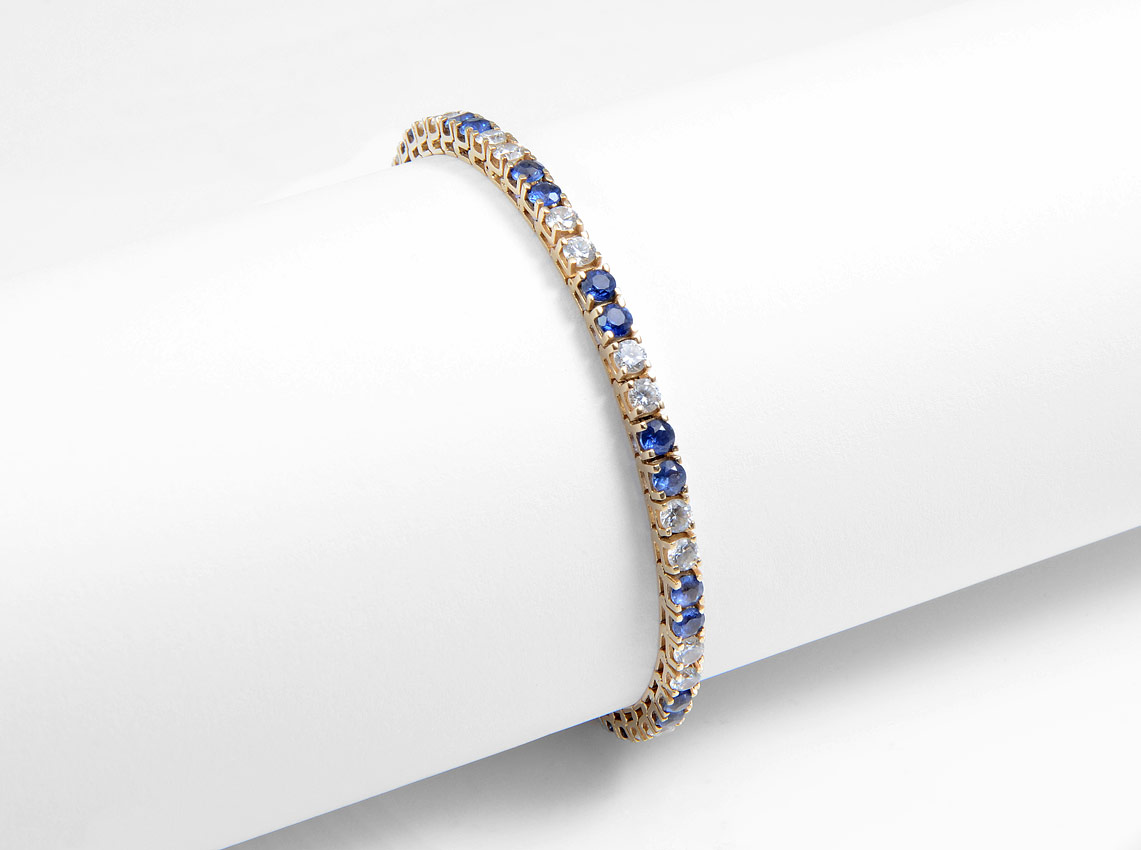 Appraisal: SAPPHIRE TENNIS BRACELET K yellow gold line bracelet alternates synthetic